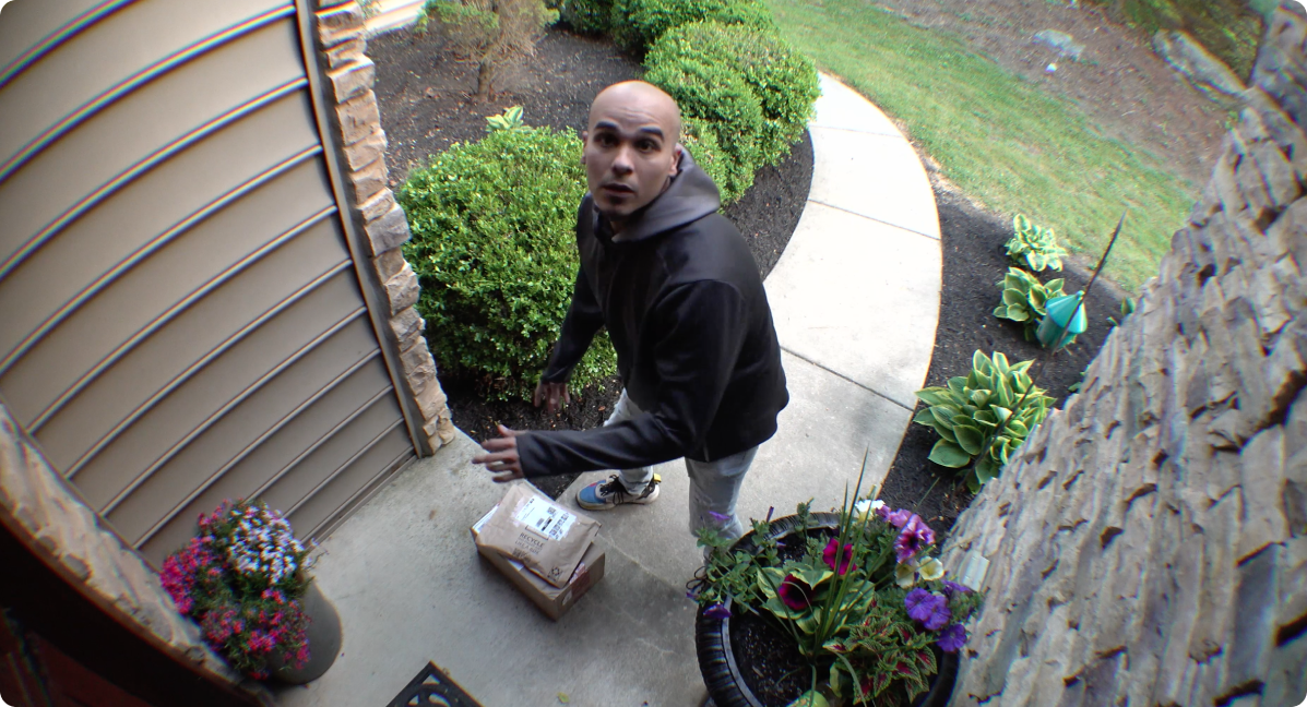 someone stealing a package in the front door of a home